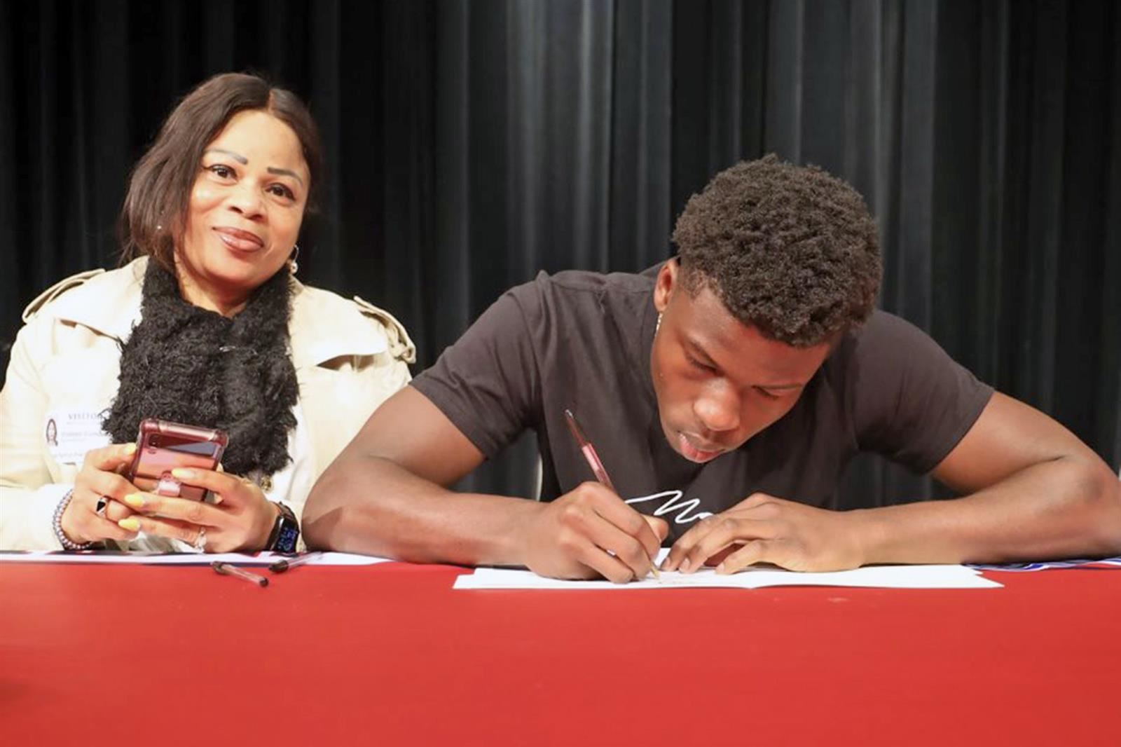 Cy Springs senior Isaiah Keller, right, signed his letter of intent to play football at Texas Wesleyan University.